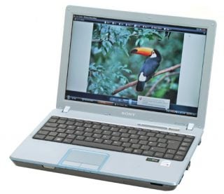 Sony VAIO VGN-C2SL laptop with a white case open at an angle displaying a colorful bird on the screen.