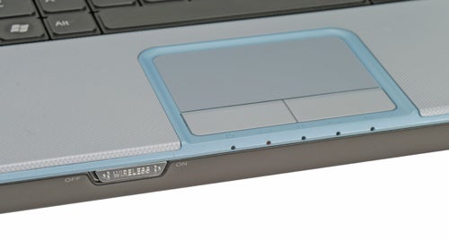 Close-up of a Sony VAIO VGN-C2SL laptop's touchpad area, highlighting the light blue borders, wireless switch, and status LEDs.