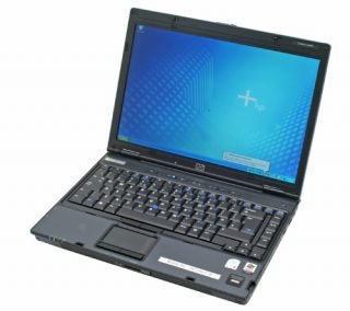 HP Compaq nc6400 laptop open and operational with logo on display screen, featuring a full keyboard and trackpad.