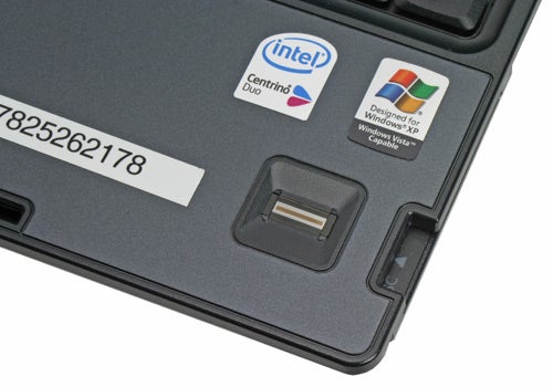 Close-up of the HP Compaq nc6400 laptop's keyboard area showing the Intel Centrino Duo sticker, Designed for Windows XP sticker, and part of the trackpoint and touchpad.