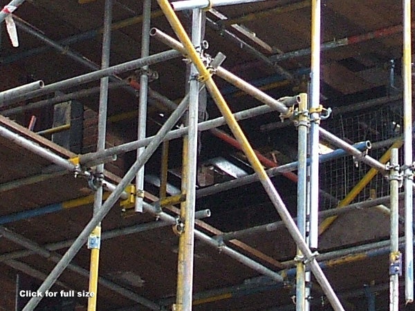 Photograph demonstrating the image quality of a Fujifilm FinePix A700 showcasing a construction scaffolding structure with metal poles, platform levels, and connection joints with a blurred background.