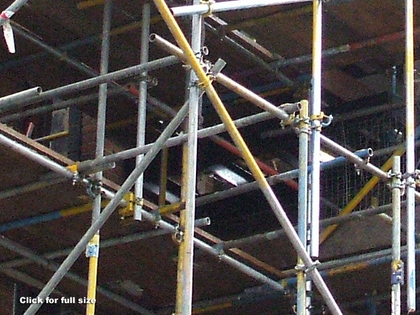 Image of a steel scaffolding structure with various crossbars and connectors, showing signs of rust and wear. There is no clear association with the Fujifilm FinePix A700 or any product review elements present in the image.