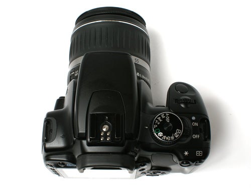 Canon EOS 400D DSLR camera with EF-S 18-55mm lens viewed from the top, showing the mode dial, shutter release, and power switch.
