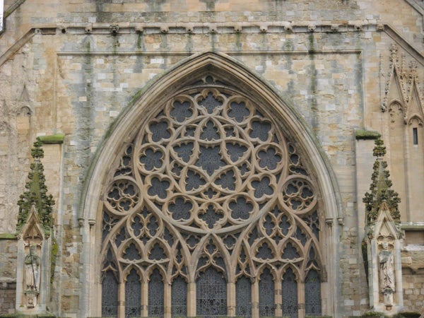 Detailed photograph of an intricate Gothic church window with stone tracery, showcasing the Nikon CoolPix L5's capability of capturing architectural details.