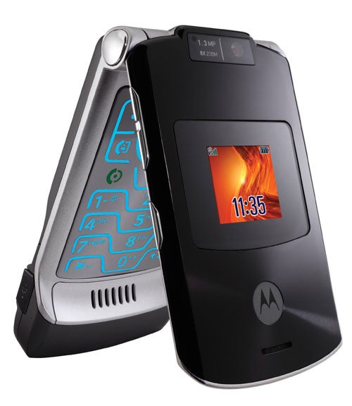 Motorola MOTORAZR V3xx flip phone shown partially open with illuminated blue keypad and external screen displaying a fiery wallpaper and the time 11:35.