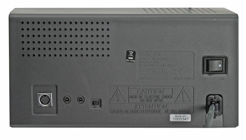 Rear view of Sony SRS-DZ10 2.1 speaker system showing the power input, various connectors, and cautionary labels.