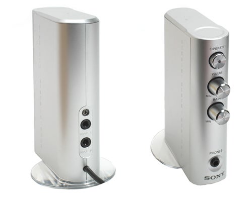 Sony SRS-DZ10 2.1 Speakers set on a white background, featuring a pair of sleek silver vertical satellite speakers with control knobs and audio input ports.