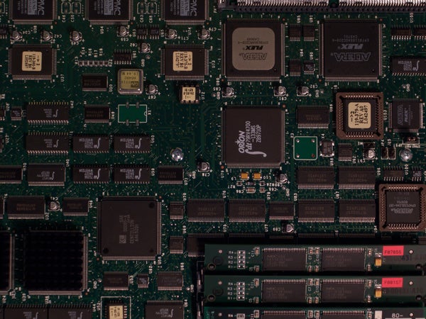 Close-up photo of an electronic circuit board with various integrated circuits, resistors, and capacitors.
