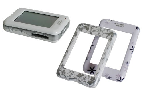 Mio Digiwalker H610 portable GPS device displayed next to two decorative faceplates with floral patterns.