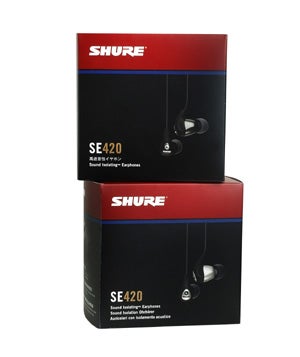 Two boxes of Shure SE420 Noise Isolating Earphones stacked with the product visible through a window on the packaging.