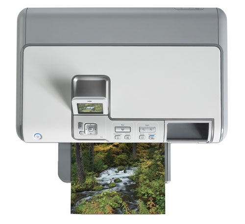 HP Photosmart D7160 inkjet printer with control panel and sample photo printout displaying a forest stream.