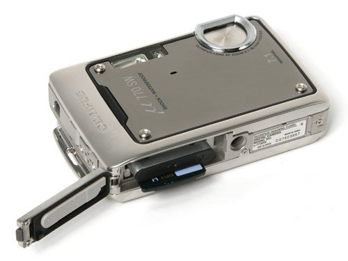 Olympus mju 770 SW digital camera shown from the battery compartment side with the compartment open revealing the battery and memory card slot.