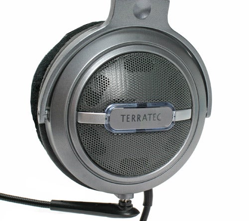 Close-up of a Terratec Headset Master 5.1 USB with a detailed view of the over-ear headphones, showing the metallic finish, black ear cushion, and the Terratec logo on the side.