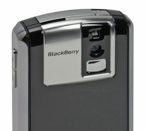 Close-up of the back of a BlackBerry Pearl smartphone showing the camera and LED flash with the BlackBerry logo visible.