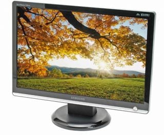 Samsung SyncMaster 226BW LCD monitor displaying a vibrant autumn landscape scene with clear skies and sun shining through the trees.
