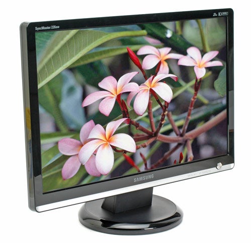 Samsung SyncMaster 226BW LCD monitor displaying vibrant pink and white frangipani flowers with a clear focus and high color fidelity on a black stand with the brand logo visible.