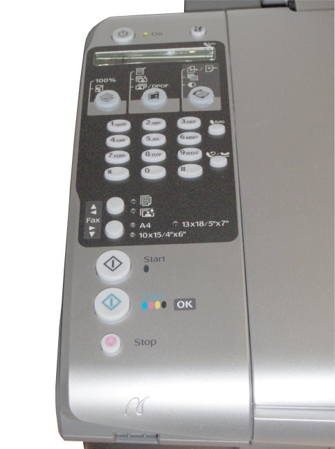 Close-up of the control panel on an Epson Stylus DX7000F multi-function printer showing buttons for various functions such as fax, copy size adjustment, and quality settings, with 'Start' and 'Stop' buttons at the bottom.