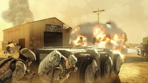 In-game screenshot from Tom Clancy's Ghost Recon Advanced Warfighter 2 showing soldiers crouched behind a vehicle for cover with an explosion in the background.