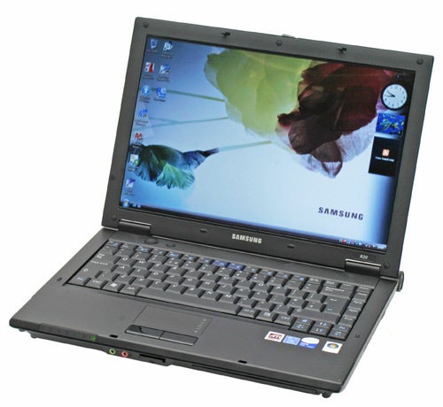Samsung R20 Aura laptop open on a table displaying desktop wallpaper with a leaf design and standard Windows icons. The Samsung logo is prominently displayed below the screen.