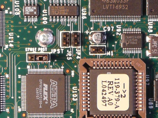 Close-up of the internal circuit board showing various electronic components including capacitors, resistors, and microchips, presumably from inside a camera like the Panasonic Lumix DMC-TZ2.