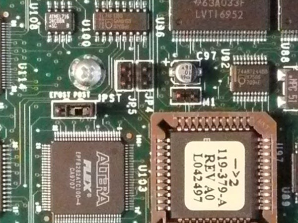 Close-up view of an electronic circuit board featuring various integrated circuits, capacitors, and other electronic components.