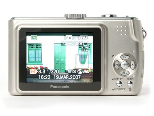Rear view of a Panasonic Lumix DMC-TZ2 camera displaying an image on its LCD screen with various camera settings visible around the screen perimeter.
