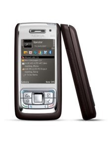Nokia E65 smartphone displayed in an upright position with the screen showing the main menu and a leather case partially visible behind it.