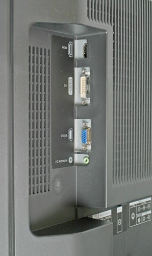 Close-up view of the side connection panel on an Evesham 32in Alqemi TX LCD TV, showing HDMI, DVI, and VGA input ports, along with audio input jacks.