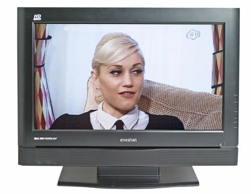 Evesham 32-inch Alqemi TX LCD TV with HD-ready badge, displaying a television show with a woman in a white blouse and black vest.