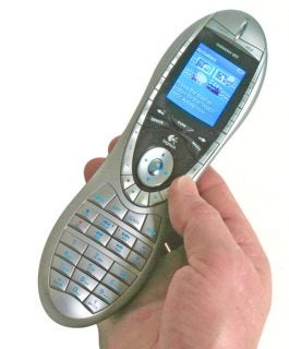 A person holding a Logitech Harmony Remote 895 Universal Remote Control with a color LCD display showing menu options.