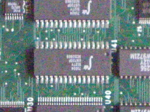 Close-up of a blurred electronic circuit board showcasing integrated circuits and microchips.