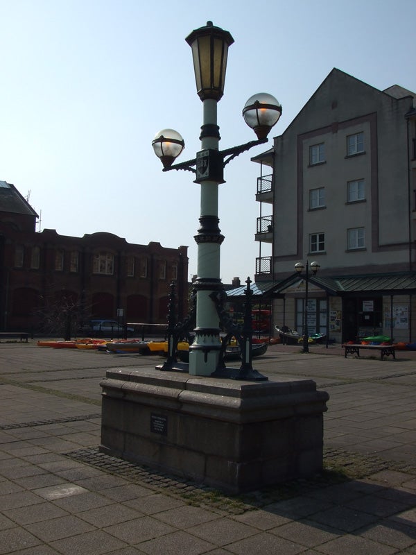 This image shows a vintage-style street lamp with multiple lanterns in an urban outdoor setting, possibly captured with a Fujifilm FinePix Z5fd camera, displaying the camera's capability to handle outdoor lighting and architecture photography.