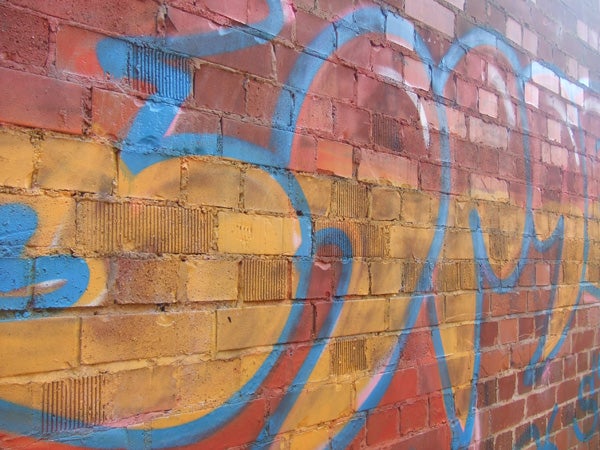 Brick wall with colorful graffiti captured by Fujifilm FinePix Z5fd camera demonstrating the camera's color rendition and clarity.