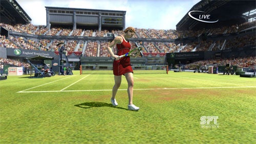 A screenshot from Virtua Tennis 3 video game showing a female player in a red outfit preparing to hit a tennis ball on a sunny grass court with a full stadium of spectators in the background.