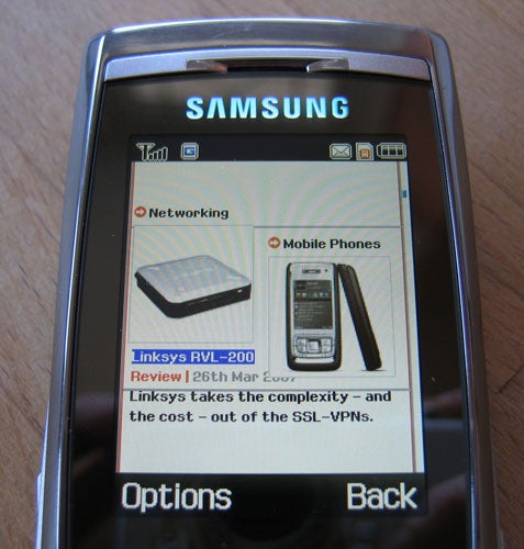Samsung SGH-D840 mobile phone displaying a product review on its screen.