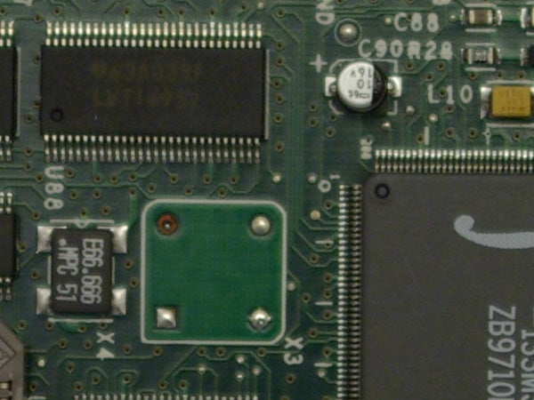 Close-up of electronic circuit board with various components, possibly the internal motherboard of a digital device such as a camera.