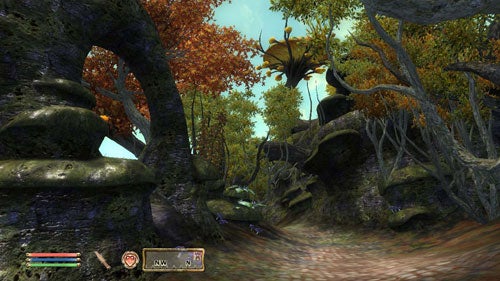 Screenshot of The Elder Scrolls IV: Shivering Isles gameplay showing a forest landscape with autumnal trees, a winding footpath, and the game's user interface at the bottom.