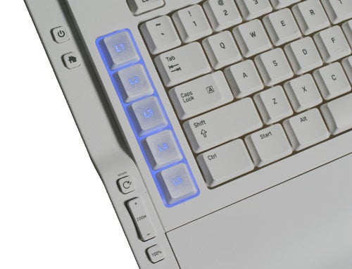 Close-up of a Razer Pro|Type Keyboard with illuminated blue keys on the left side, white keys in the center, and multimedia function keys.
