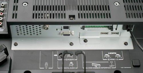 Close-up view of the Toshiba Regza 42C3030D 42-inch LCD TV's rear connectivity options including HDMI, component, and various audio output ports.