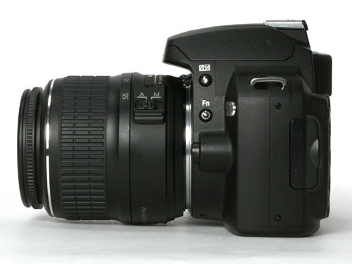 Nikon D40x DSLR camera with lens attached, displayed from the side view showing focus mode switch and function button.