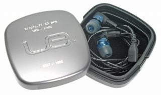 Ultimate Ears triple.fi 10 Pro earphones with metallic carrying case displaying the UE logo, model name, and a frequency range of 10Hz - 17kHz embossed on the lid, with the earphones and black cable neatly placed inside the open case.