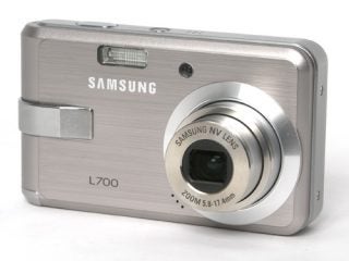 Samsung L700 digital camera displayed against a white background, showing the camera's front with lens, brand name, and model number.