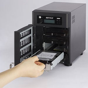 A person inserting a hard drive into the Buffalo Technology TeraStation Pro II 1.0TB Network Attached Storage device.