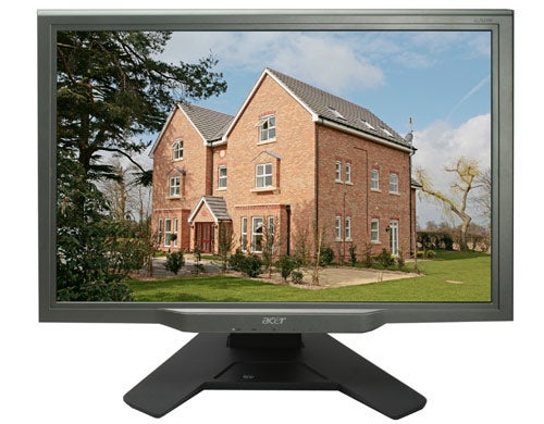 Acer AL2623W 26-inch widescreen LCD monitor displaying a vibrant image of a brick house with a large yard.