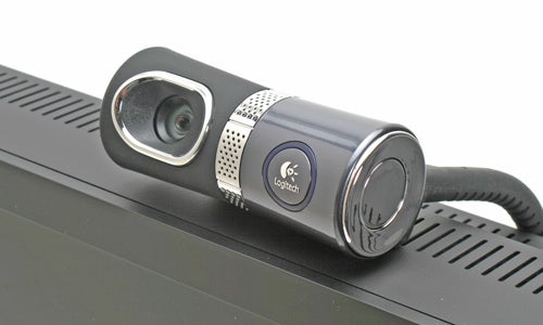 Logitech Quickcam Ultra Vision webcam with silver accents, resting on top of a monitor.