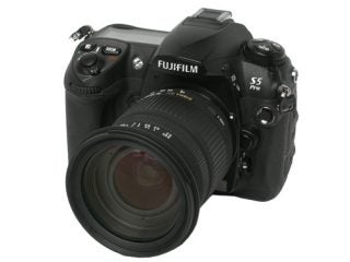 Fujifilm S5 Pro DSLR camera with a black body and attached zoom lens, displayed against a white background.