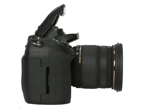 Fujifilm S5 Pro DSLR camera with lens attached, viewed from the side with the pop-up flash open.