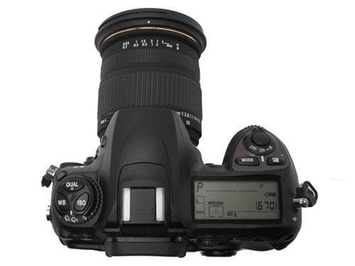 Fujifilm S5 Pro DSLR camera with a black lens mounted on top, viewed from above showing the LCD screen and control dials on the right.