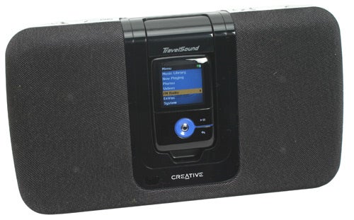 Creative Zen V Plus 8GB MP3 player docked into a compatible black speaker system, displaying the music menu on its screen.