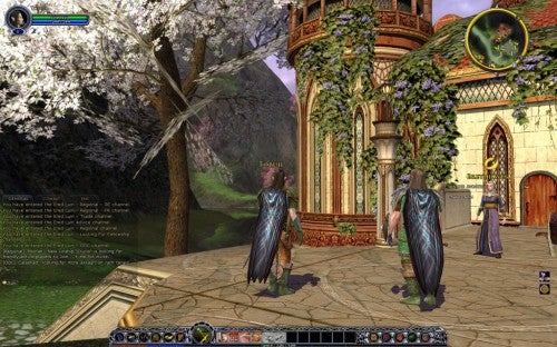 Screenshot from the MMORPG Lord of the Rings Online: Shadows of Angmar showing two player characters in cloaks standing in a town with blossoming trees, fantasy buildings, and an NPC in the background.